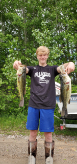 Carson Selman of Tawas City with his Large Mouth Bass