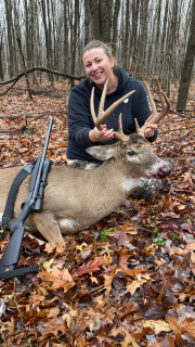 Jordyn Glesken from Chesaning baggedan 8 point in Saginaw County!  My husband tagged out during bow season so he took me out opening day. We got into our spot pretty early hoping the neighbors walking in would send some deer our way. It was barely 7:30 and this buck came in about 60 yards away and he was moving pretty quickly and by the time I had got my gun pulled up and out the window, the buck had already passed through my biggest shooting lane. My husband grunted at it to stop it but we had different angles and he stopped it in an opening to him but the deer was right behind a tree for me. He started walking again and I told my husband to grunt again hoping it would stop him in an opening and not scare him off, he grunted and the buck stopped for a brief second and all I could see was the front shoulder forward the rest was behind a tree. I let him have it! I wasn’t even sure how big he was at that point it happened so fast. He took off running into some thicket and I was nervous I hit him too far forward in the brisket so we waited a few hours and then got down and he was laying about 40yards from where I shot him! I was super pumped, it was the first deer shot out of the shack we were in, that my husband and I built together last summer. Big Buck Down